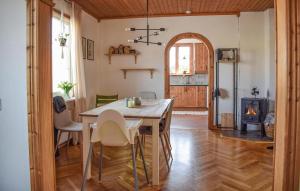 a kitchen and dining room with a table and a stove at Awesome Home In Sölvesborg With Wifi in Sölvesborg