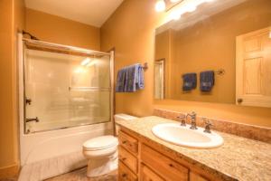 a bathroom with a sink and a shower and a toilet at Moondance Lodge in Big Sky Mountain Village +19 photos
