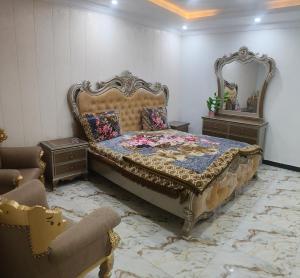 a bedroom with a large bed and a mirror at Koh E Sukoon Apartments in Patriata