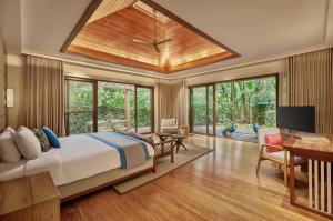 a bedroom with a large bed and a desk at The Farm at San Benito, Autograph Collection in Lipa +122 photos