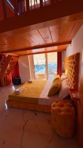 a large bed in a room with a large window at Romance Apartments in Sarandë