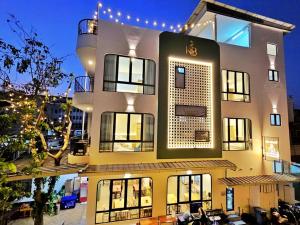 a large building with lights on the side of it at Serene Residence in Vientiane