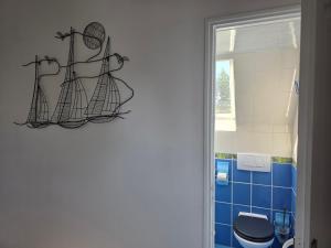 a bathroom with a toilet and blue tiles at Villa du Marais in Ri +56 photos