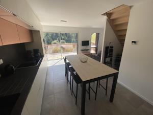 a kitchen with a table and chairs in a room at Duplex 3 chambres Etoile du sud in Le Lioran