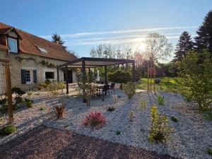 a garden with a pavilion with a table and chairs at Villa du Marais in Ri