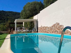 a swimming pool in front of a house at Villa Mariposa exclusive private pool in Budoni