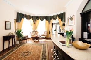 a living room with a counter with flowers on it at Hotel Pavlov in Karlovy Vary