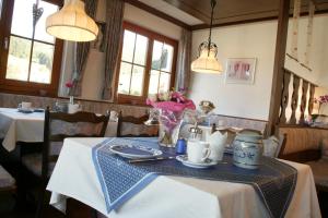 a table in a restaurant with a blue and white table cloth at Landhaus Mast in Baiersbronn