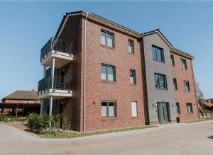 a brick building with balconies on the side of it at Stay2sleep, Self-Check-In in Dinklage