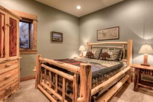 a bedroom with a wooden bed in a room at Lone View Lodge in Big Sky Mountain Village