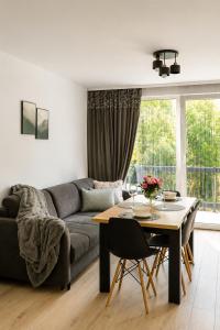 a living room with a couch and a table at VeloDomki Żywiec - domki nad Jeziorem Żywieckim in Żywiec