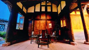 a room with chairs and a table on a patio at Nan Court - Nanyuan,Leshan in Leshan