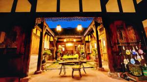 a patio with a table in the middle of a building at Nan Court - Nanyuan,Leshan in Leshan