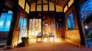 a room with two chairs and a table in a building at Nan Court - Nanyuan,Leshan in Leshan