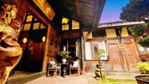 a building with a table and chairs in front of it at Nan Court - Nanyuan,Leshan in Leshan +123 photos