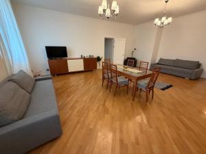 a living room with a table and chairs and a couch at Spacious 2 bedroom apartment, Old Town Riga in Riga