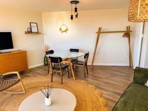 a living room with a table and chairs at La Tour Myra in Valras-Plage