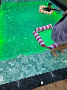 two people in the water in an indoor swimming pool at Minhtan2 villa in Dong Hoi