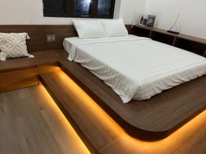 a bed in a room with lights on the floor at Minhtan2 villa in Dong Hoi