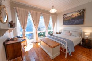 a bedroom with a bed and a large window at Dunkeld Secret Garden in Dunkeld