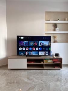 a living room with a flat screen tv on a table at Georges House in Nea Moudania