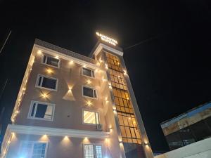 a building with lights on it at night at Hotel Gangotri Suites in Haridwār
