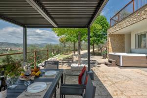 a patio with a table and chairs with a view at Sporting Hotel San Felice in Illasi