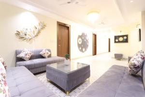 a living room with a couch and a table at Hotel Gangotri Suites in Haridwār