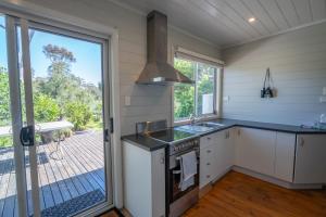 a kitchen with a sink and a stove at Dunkeld Secret Garden in Dunkeld