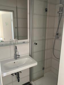a bathroom with a sink and a shower at Hotel Sylvia in Norderney +20 photos