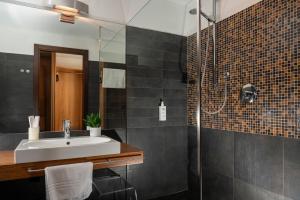 a bathroom with a sink and a shower at Hotel Europa Belluno in Belluno +25 photos