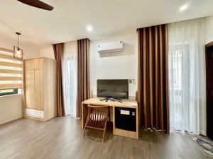 a room with a desk with a computer in it at SOLEIL HOSTEL in Hue