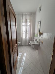 a bathroom with a sink and a toilet at B&B Villa Clara in Dossobuono