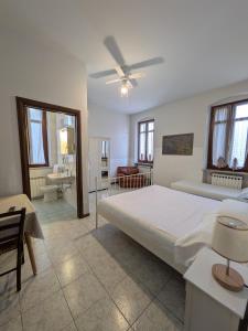 a bedroom with a large bed and a bathroom at B&B Villa Clara in Dossobuono