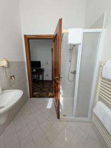a bathroom with a shower and a tub and a sink at B&B Villa Clara in Dossobuono