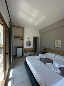 a bedroom with two beds and a large window at Zefiros in Agios Ioannis Pelio +158 photos