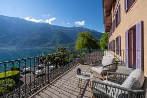 a balcony with a view of a lake and mountains at Hotel Seeburg - Adults only in Ringgenberg
