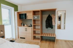 a bedroom with a built in closet with a bed and a closet at Stay2sleep, Self-Check-In in Dinklage
