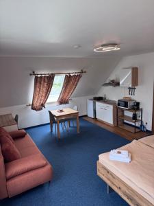 a living room with a couch and a table at Hotel Kelkheimer Hof in Kelkheim