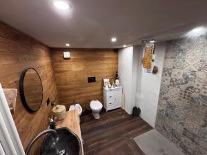 a bathroom with a toilet and a sink and a mirror at La Caso dal Chiot - Chalet in Elva +20 photos