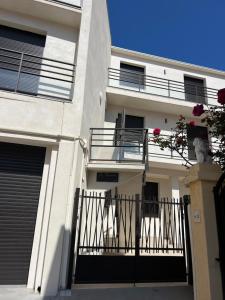 a white building with a balcony and a fence at Studio Noélie in Antibes