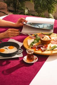 a person sitting at a table with a plate of food at Green House Garden Park Hotel in Istanbul