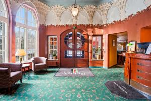 a living room with a large room with orange walls at Imatran Valtionhotelli in Imatra