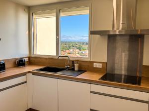 a kitchen with a sink and a window at La Tour Myra in Valras-Plage +11 photos