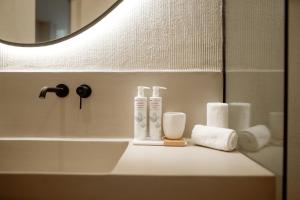 a bathroom counter with a sink and a mirror at MINT Keramoti in Keramoti +39 photos