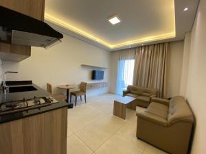 a kitchen and living room with a couch and a table at Sunshine Resort - Tabarja, Lebanon in An Nā‘ūrah