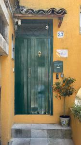 a green door on the side of a building at MiLù Sicily House in Modica