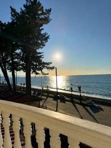 a view of the ocean from a white railing at У Царицы in Kobuleti