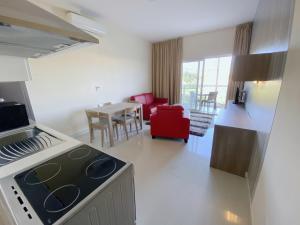 a kitchen and living room with a stove and a table at Vista Point - Cast Renting in Msida