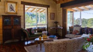 a living room with couches and a table and windows at Mountain View Farm in Portland